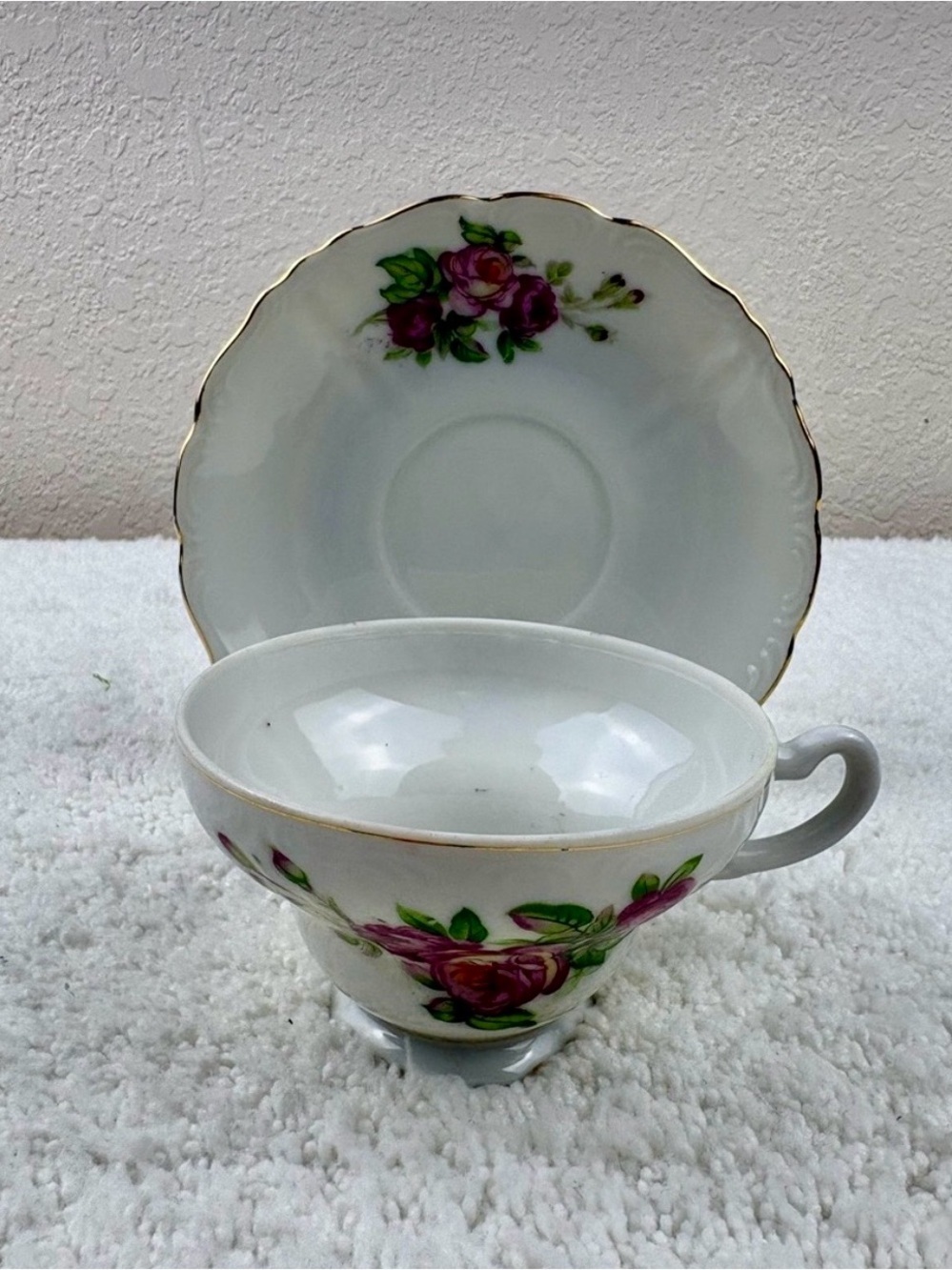 Vintage Porcelain Teacup & Saucer Set Featuring Pink Roses on a White Background